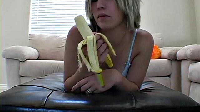 Teasing teen peels banana
