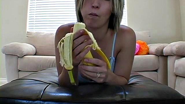 Teasing teen peels banana