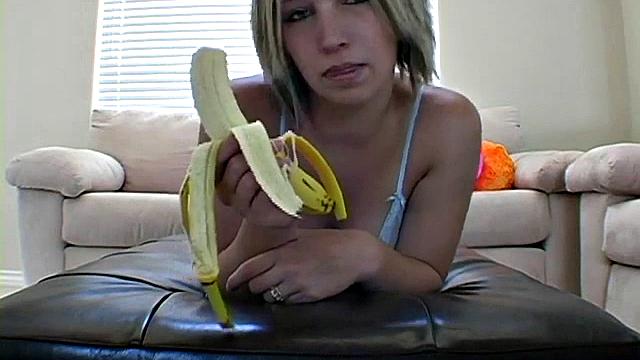 Teasing teen peels banana