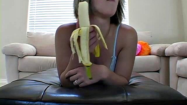 Teasing teen peels banana
