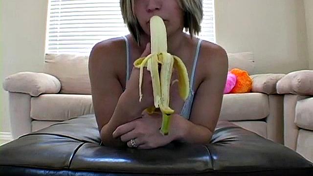Teasing teen peels banana