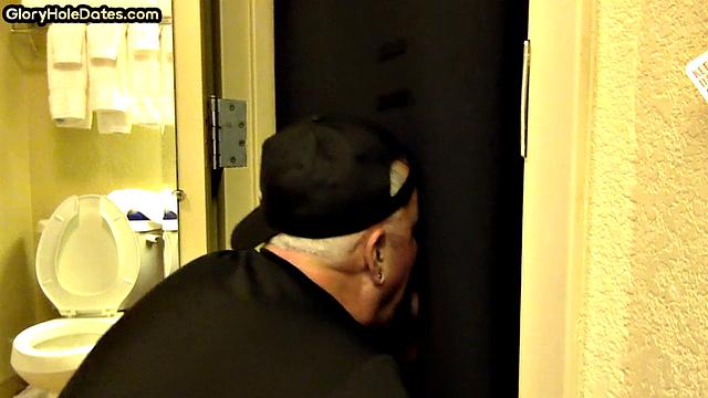 Gloryhole DILF sucks cock with eager mouth near toilet