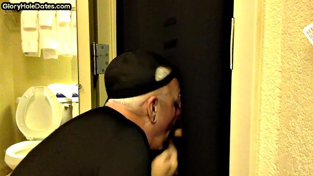 Gloryhole DILF sucks cock with eager mouth near toilet