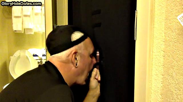 Gloryhole DILF sucks cock with eager mouth near toilet