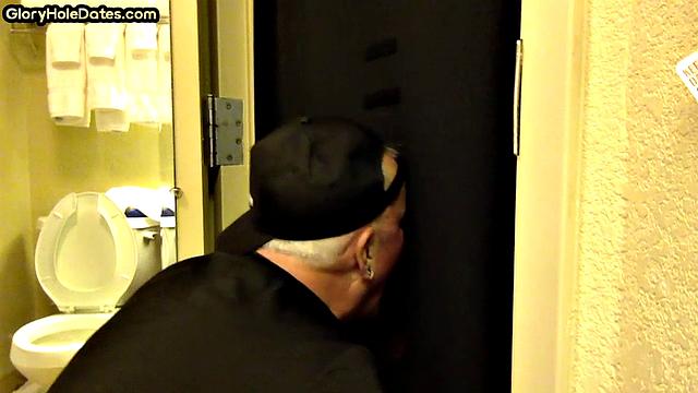 Gloryhole DILF sucks cock with eager mouth near toilet