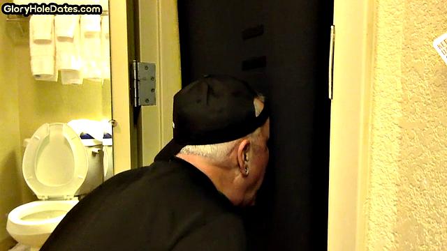 Gloryhole DILF sucks cock with eager mouth near toilet