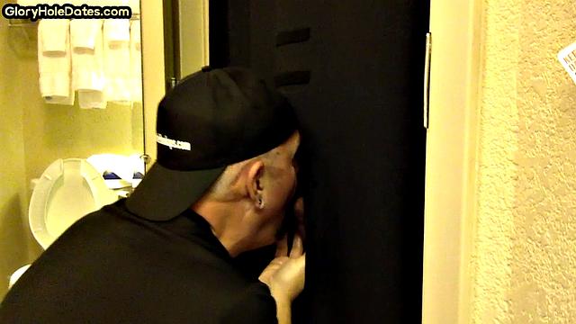 Gloryhole DILF sucks cock with eager mouth near toilet