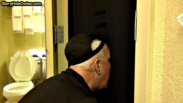 Gloryhole DILF sucks cock with eager mouth near toilet