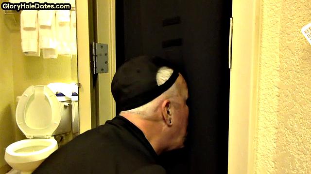 Gloryhole DILF sucks cock with eager mouth near toilet