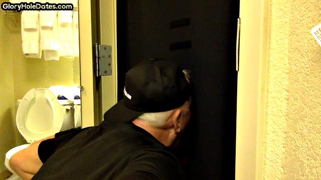 Gloryhole DILF sucks cock with eager mouth near toilet