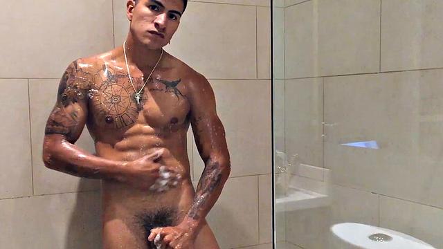 Our featured solo boy of the week is Erick, a muscular and inked young Latino who invites us to watch as he jerks off in the shower.
