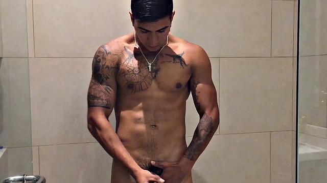 Our featured solo boy of the week is Erick, a muscular and inked young Latino who invites us to watch as he jerks off in the shower.