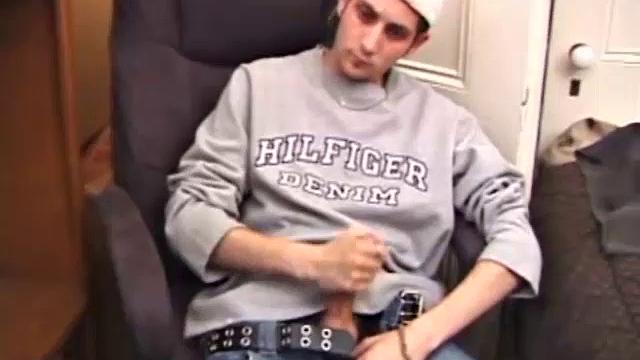 As a porno plays, Aaron strokes himself and pulls his cock out of his jeans. After a nice long stroke show, this man spills his warm sticky cum onto the bed.