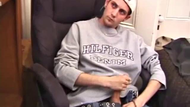 As a porno plays, Aaron strokes himself and pulls his cock out of his jeans. After a nice long stroke show, this man spills his warm sticky cum onto the bed.