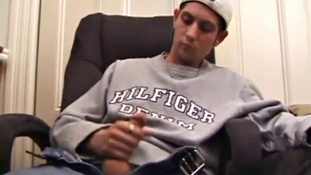 As a porno plays, Aaron strokes himself and pulls his cock out of his jeans. After a nice long stroke show, this man spills his warm sticky cum onto the bed.