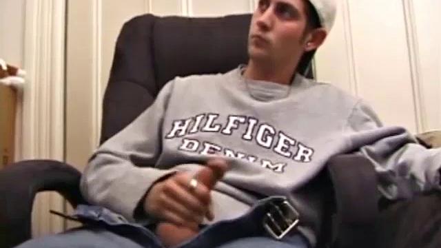 As a porno plays, Aaron strokes himself and pulls his cock out of his jeans. After a nice long stroke show, this man spills his warm sticky cum onto the bed.