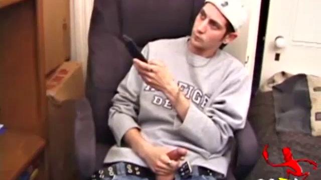 As a porno plays, Aaron strokes himself and pulls his cock out of his jeans. After a nice long stroke show, this man spills his warm sticky cum onto the bed.