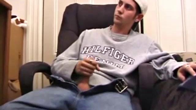 As a porno plays, Aaron strokes himself and pulls his cock out of his jeans. After a nice long stroke show, this man spills his warm sticky cum onto the bed.