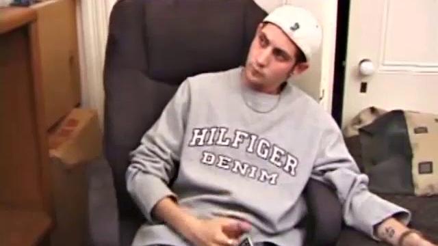 As a porno plays, Aaron strokes himself and pulls his cock out of his jeans. After a nice long stroke show, this man spills his warm sticky cum onto the bed.