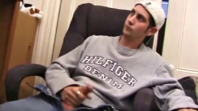 As a porno plays, Aaron strokes himself and pulls his cock out of his jeans. After a nice long stroke show, this man spills his warm sticky cum onto the bed.