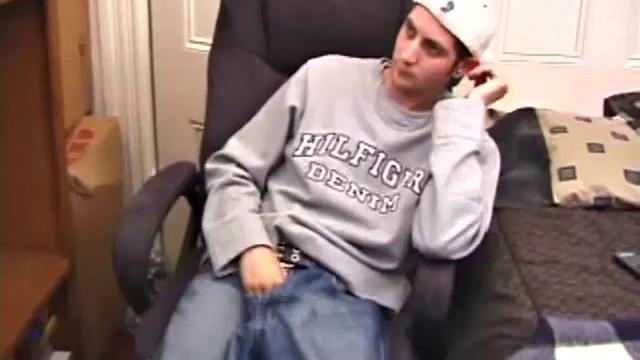 As a porno plays, Aaron strokes himself and pulls his cock out of his jeans. After a nice long stroke show, this man spills his warm sticky cum onto the bed.