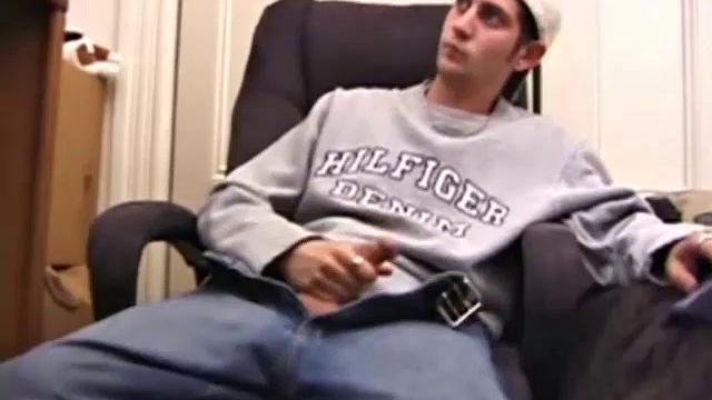 As a porno plays, Aaron strokes himself and pulls his cock out of his jeans. After a nice long stroke show, this man spills his warm sticky cum onto the bed.