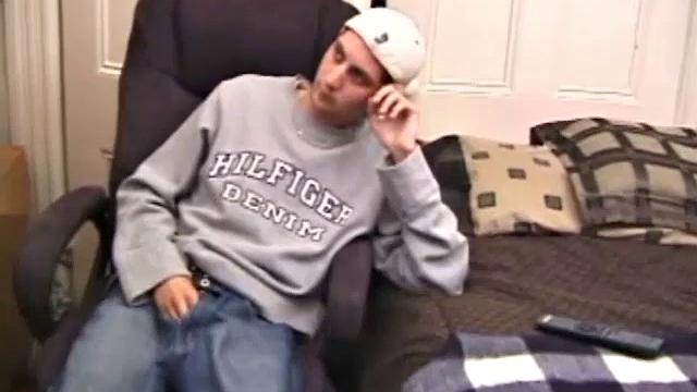 As a porno plays, Aaron strokes himself and pulls his cock out of his jeans. After a nice long stroke show, this man spills his warm sticky cum onto the bed.