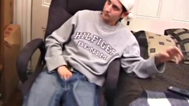 As a porno plays, Aaron strokes himself and pulls his cock out of his jeans. After a nice long stroke show, this man spills his warm sticky cum onto the bed.