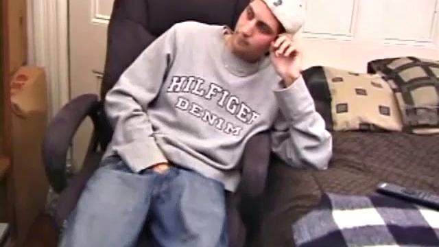 As a porno plays, Aaron strokes himself and pulls his cock out of his jeans. After a nice long stroke show, this man spills his warm sticky cum onto the bed.