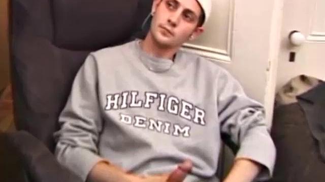 As a porno plays, Aaron strokes himself and pulls his cock out of his jeans. After a nice long stroke show, this man spills his warm sticky cum onto the bed.