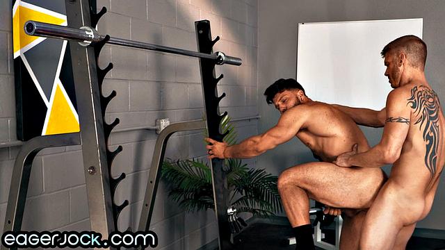 Muscled stud bouncing on gym coach