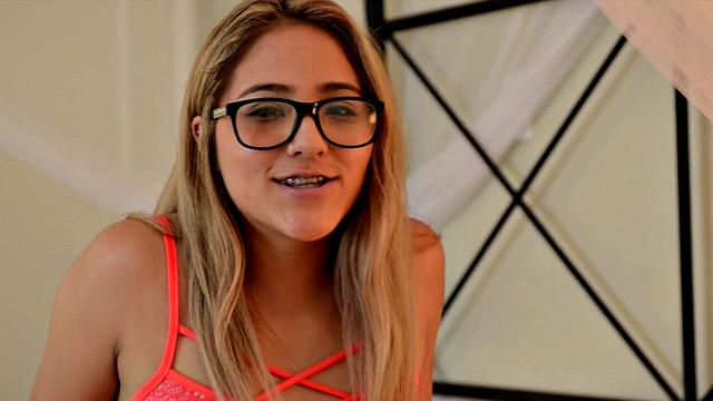 Nerdy Mila lounges in bed and cums