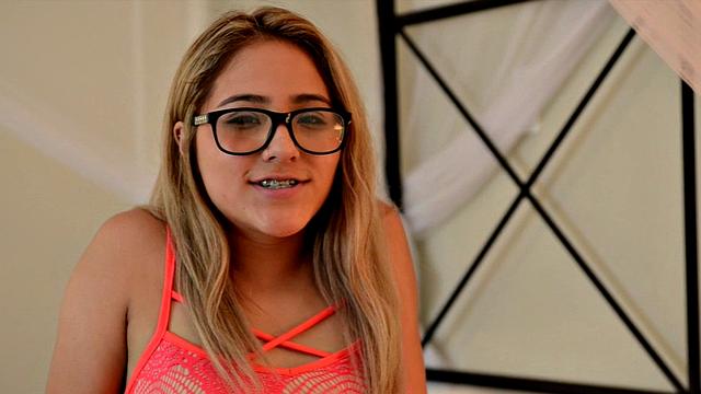 Nerdy Mila lounges in bed and cums