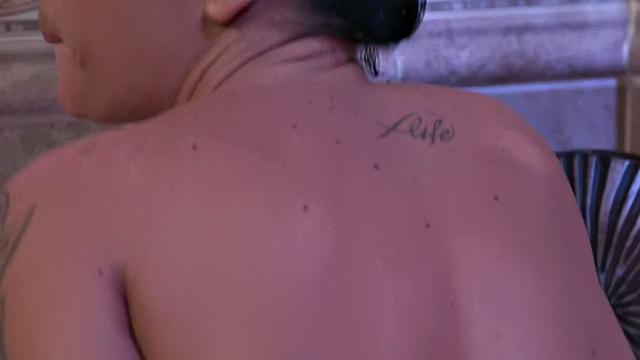 Kinky tattooed brunette and her ebony lover fingerbang in the bathroom