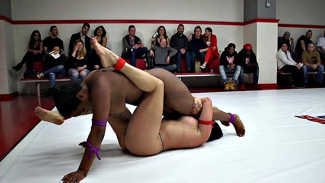 Public lesbian wrestlers fight in arena in front of a crowd