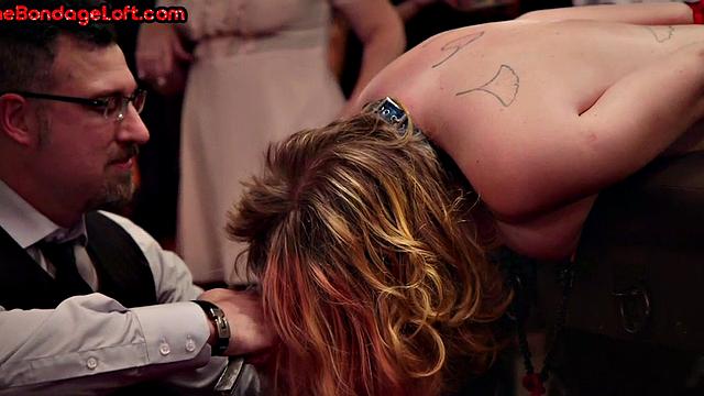 Public BDSM sub gets a hair cutting lesson in front of audience