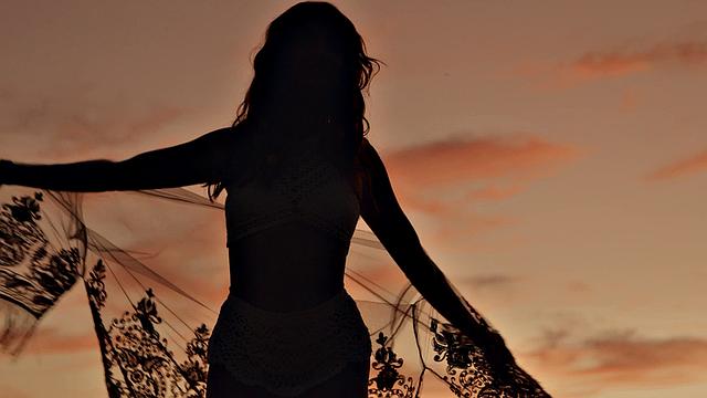 A hot redhead in high heels finger her trimmed pussy and lingerie while playing with herself in the indoors