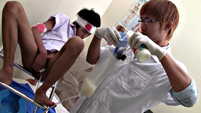 Pissing Asian twink enjoys bareback sex with doctor