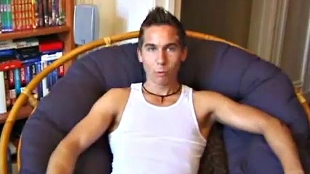 Brocks pops in a porn video and starts to strip. The man sports a hard cock, stroking it before exploding on his face and chest.