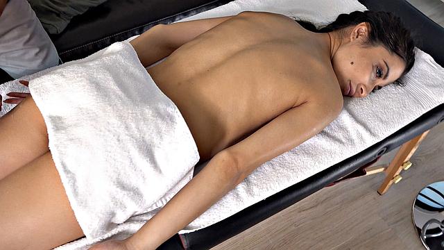 Oiled babe orgasms on the table