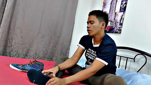This boy next door type of Asian twink tries to not jerk off so much by listening to some tunes. But he's got such an obsession with male feet fetish, nothing can keep his mind off of it.