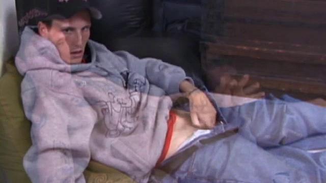 Seth sits on the floor with a porn video playing, and rubs his dick through his pants until the zipper is about to bust open. He unbuckles, releases his snake, and grabs the lube.