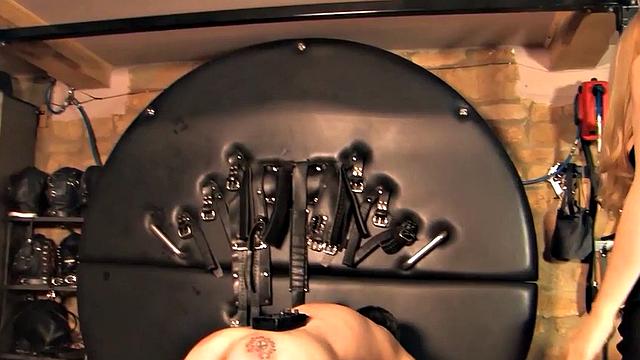 CFNM leather domina whipping sub in BDSM session