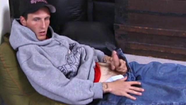 Seth sits on the floor with a porn video playing, and rubs his cock through his pants until the zipper is about to bust open. He releases his snake, shakes it around for the camera, and grabs the lube.