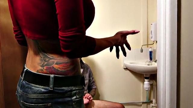 CFNM busty tattooed MILF jerks hard dude in toilet