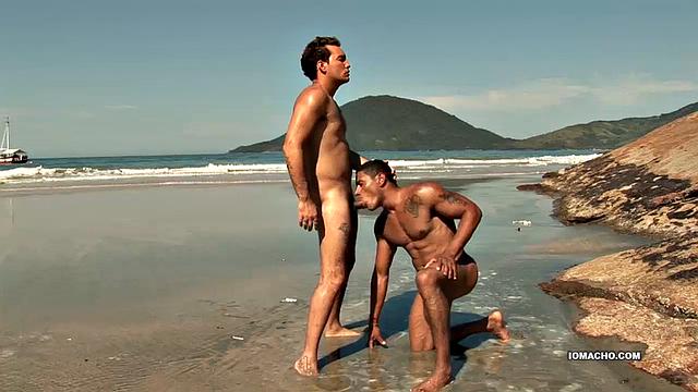 While visiting a beautiful island, horny Latinos Alber and Antony find a big flat rock, next to the crashing waves, to fuck. Once naked, Alber sucks his top's cock until it's hard and then hops on for a raw ride.