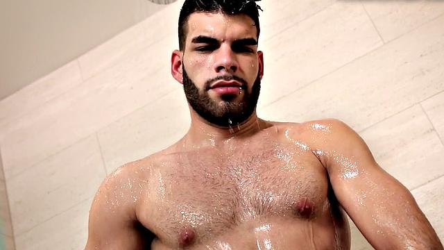 Bearded jock masturbates in close-up action after shower