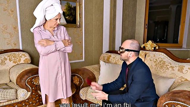 Watch as a mature blonde seduces her young guest with her natural tits and glasses on the couch