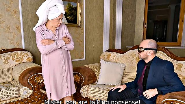 Watch as a mature blonde seduces her young guest with her natural tits and glasses on the couch