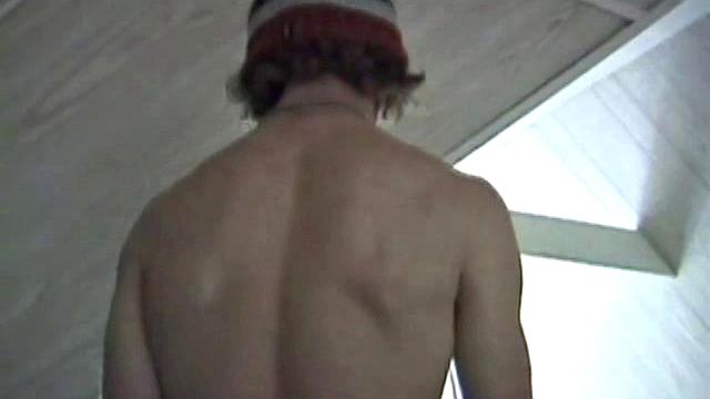 Adam relaxes on the floor watching porn video, strokes cock, plays with butthole, and blasts cum load onto skateboard